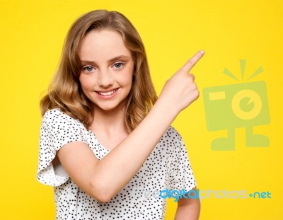 Smiling Girl Indicating Upwards Stock Photo