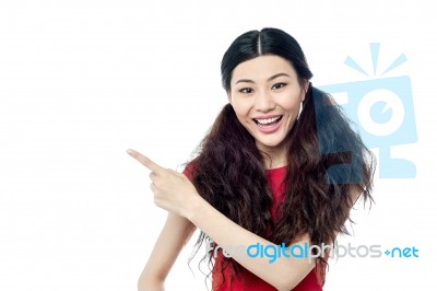 Smiling Girl Pointing At Something Stock Photo