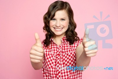 Smiling Girl Showing Thumbs Up Stock Photo