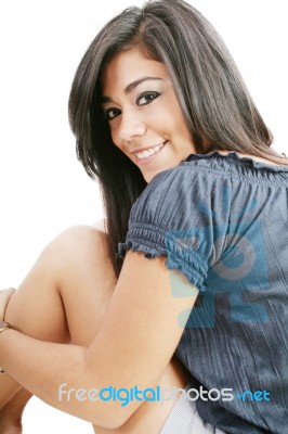 Smiling Girl Sitting On Floor Stock Photo