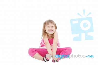 Smiling Girl Sitting On Floor Stock Photo