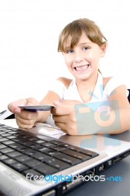 Smiling Girl With Laptop And Credit Card Stock Photo