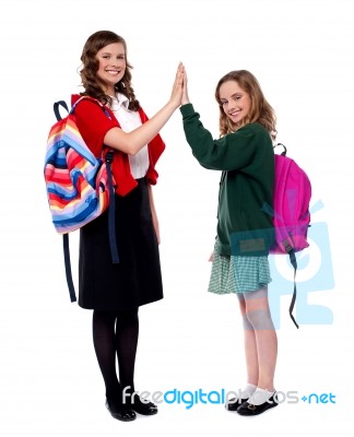 Smiling Girls Giving High Five Stock Photo