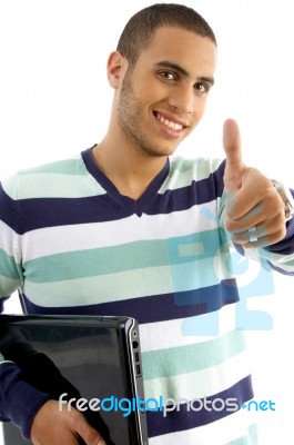 Smiling Guy Holding Notebook Showing Thumbs Up Stock Photo