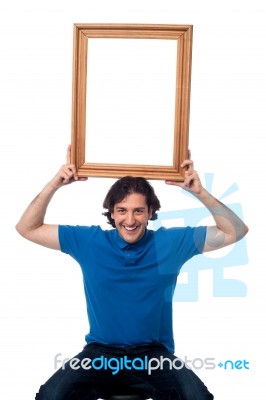 Smiling Guy Holding Onto Memories Stock Photo