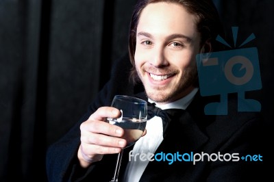 Smiling Guy In Tuxedo Drinking Cocktail Stock Photo