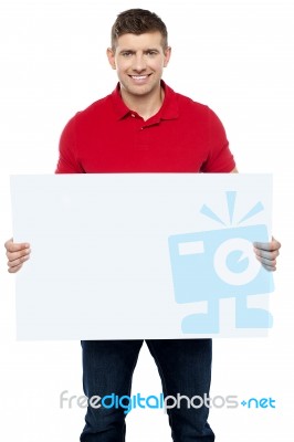 Smiling Guy Presenting Blank Board Stock Photo