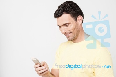 Smiling Guy Sending A Text Message Stock Photo