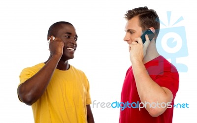 Smiling Guys Talking Over Mobile Stock Photo