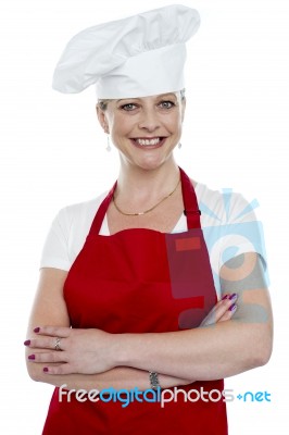 Smiling Lady Cook With Crossed Arms Stock Photo