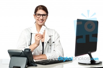 Smiling Lady Doctor Holding Pack Of Medicine Stock Photo