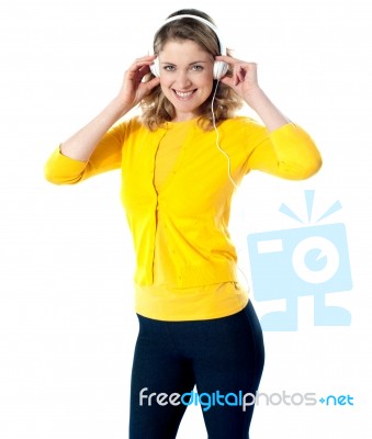 Smiling Lady Enjoying Music Stock Photo