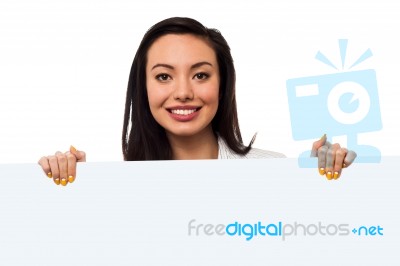 Smiling Lady Holding Billboard For Ad Stock Photo