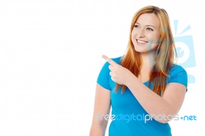 Smiling Lady Looking And Pointing Away Stock Photo