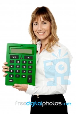 Smiling Lady Showing Big Green Calculator Stock Photo