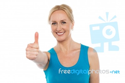 Smiling Lady Showing Thumbs Up Stock Photo