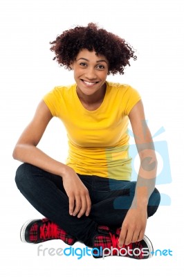 Smiling Lady Sitting Legs Crossed On The Floor Stock Photo