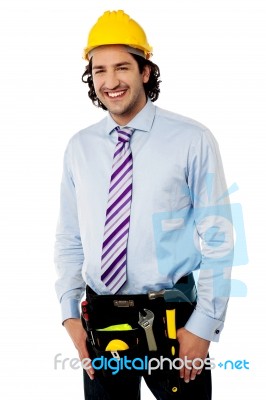 Smiling Male Architect Wearing Tool Belt Stock Photo