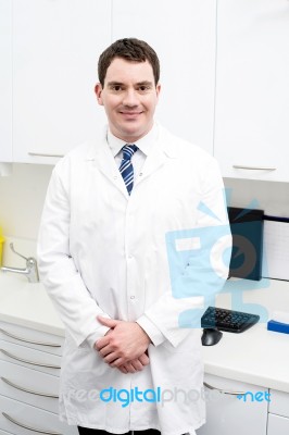 Smiling Male Doctor Posing In Lab Coat Stock Photo