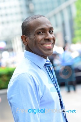 Smiling Male Executive Posing In Street Stock Photo