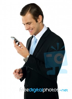 Smiling Male Reading Message Stock Photo