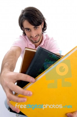 Smiling Male Showing Books Stock Photo