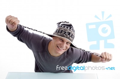 Smiling Male Stretching His Cap Stock Photo