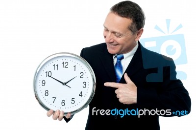 Smiling Man Holding A Clock In His Hands Stock Photo