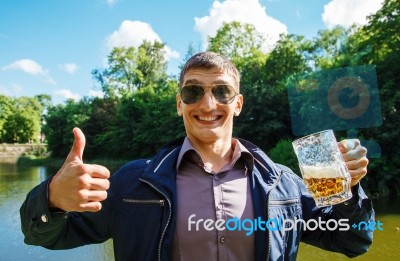 Smiling Man Holding A Large Beer Mug Stock Photo