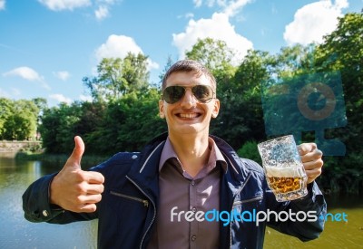 Smiling Man Holding A Large Beer Mug Stock Photo