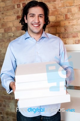 Smiling Man Holding Pizza Boxes Stock Photo