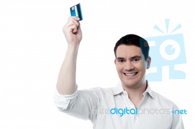 Smiling Man Holding Up His Credit Card Stock Photo