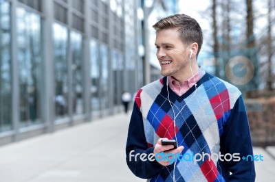 Smiling Man Listens Music In A Street Stock Photo