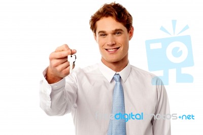 Smiling Man Offering House Key Stock Photo