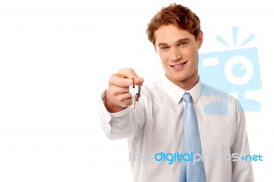 Smiling Man Offering House Key Stock Photo