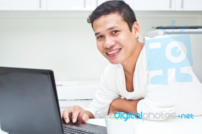 smiling Man Operating Laptop Stock Photo