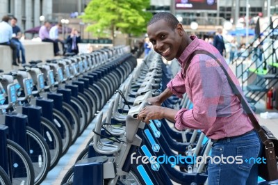 Smiling Man Parking His Bicycle Stock Photo