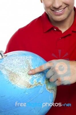 Smiling Man Pointing Globe Stock Photo