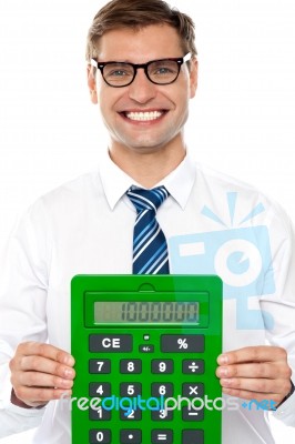 Smiling Man Showing Calculator Stock Photo