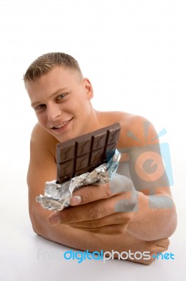 Smiling Man Showing Chocolate Stock Photo