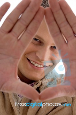 Smiling Man Showing Hand Gesture Stock Photo