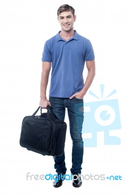 Smiling Man Standing With Bag Stock Photo