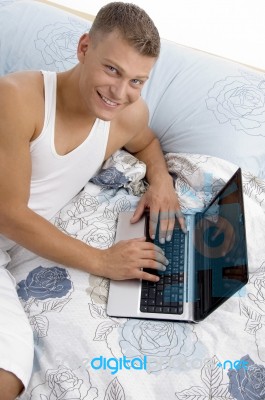 Smiling Man Working On Laptop Stock Photo