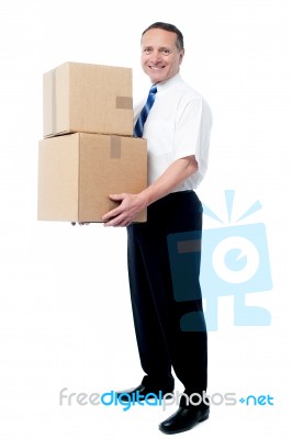 Smiling Mature Man Carrying Boxes Stock Photo