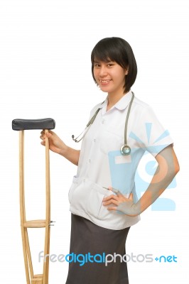 Smiling Medical Doctor Holding Crutches Stock Photo