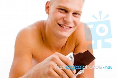 Smiling Muscular Guy With Chocolate Stock Photo