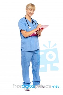 Smiling Nurse Preparing Case Sheet Of A Patient Stock Photo