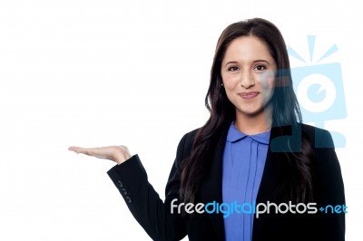 Smiling Sales Woman Presenting Something Stock Photo