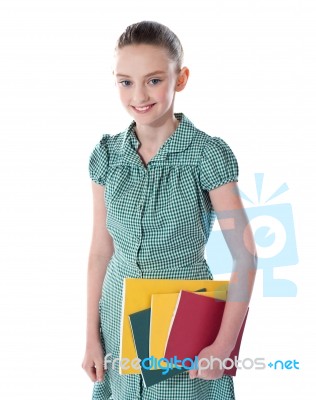 Smiling School Girl Holding Books Stock Photo