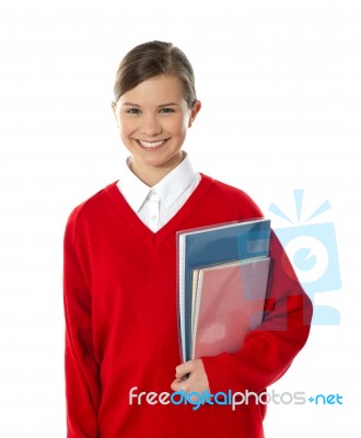 Smiling Schoolgirl Holding Books Stock Photo